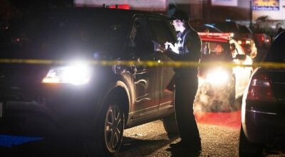 A sheriff deputy works at the scene of a shooting in Half Moon Bay in California