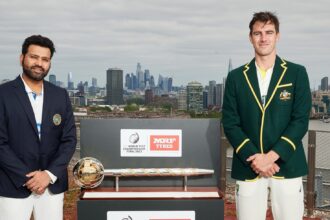 India's captain Rohit Sharma and Australia's captain Pat Cummins pose with the trophy ahead of the World Test Championship Final