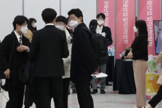 People looking around different booths at a job fair in Seoul