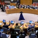Representatives vote on a draft resolution during a UN Security Council meeting at the UN headquarters in New York
