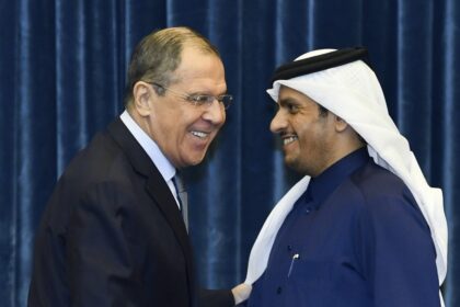 Russian Foreign Minister Sergei Lavrov (L) shakes hands with Qatari Deputy Prime Minister and Foreign Minister Sheikh Mohammed bin Abdulrahman Al-Thani