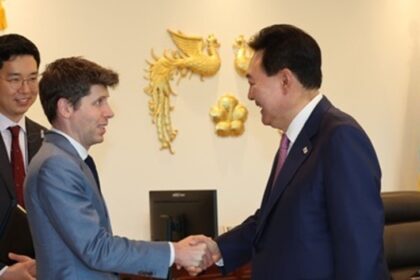 South Korean President Yoon Suk Yeol (R) shakes hands with Sam Altman