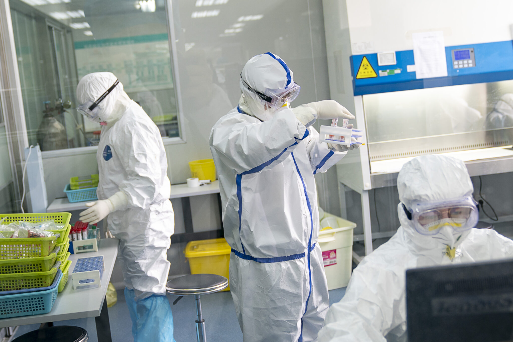 Staff members work in a laboratory in Wuhan