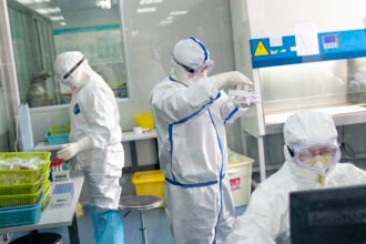 Staff members work in a laboratory in Wuhan