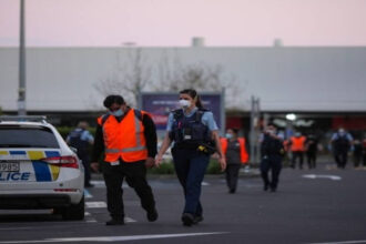 Police officers stand guard near Auckland