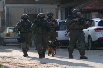 Israeli soldiers patrol a street in Salem village