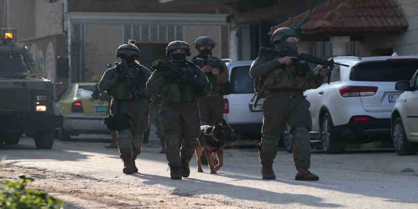 Israeli soldiers patrol a street in Salem village
