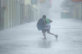 A man walks in the rain